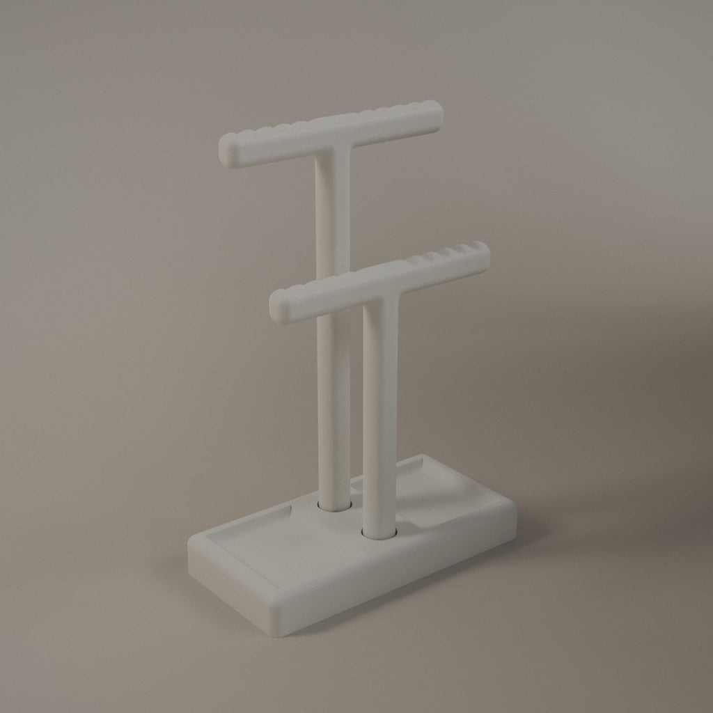 White jewellery holder with a tall and a short T bar on a tray