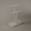 White jewellery holder with a tall and a short T bar on a tray