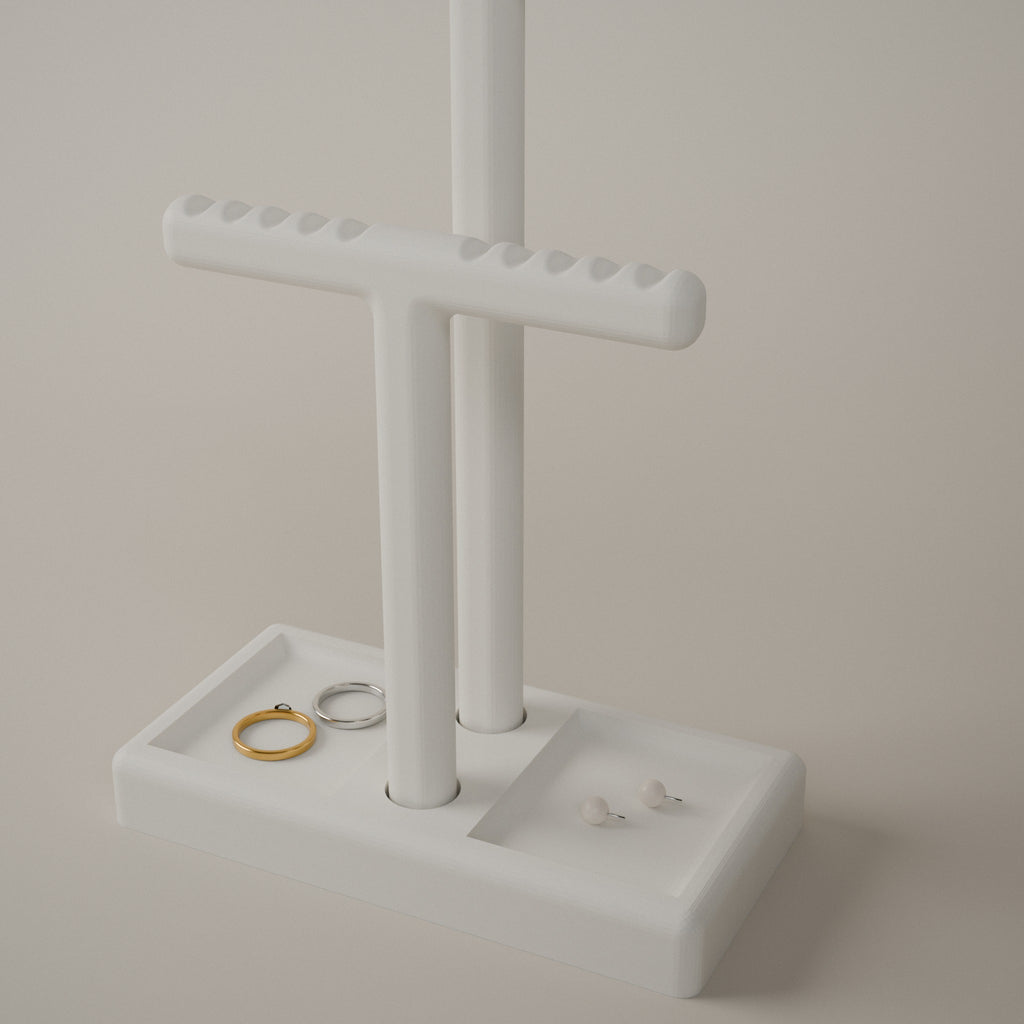 Close up of the notches on the short bar, with rings and stud earrings in the tray