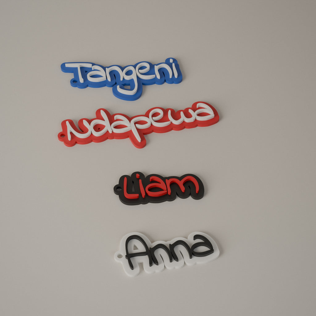 Four name keyrings in blue, red, black and white with different letter colours